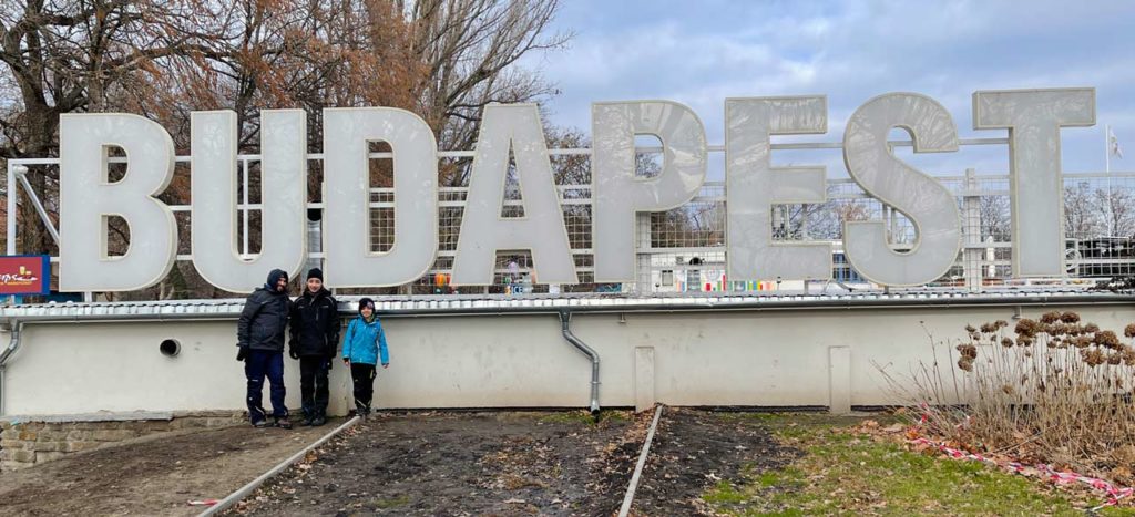 vater-mit-kindern-vor-weissem-schriftzug-budapest