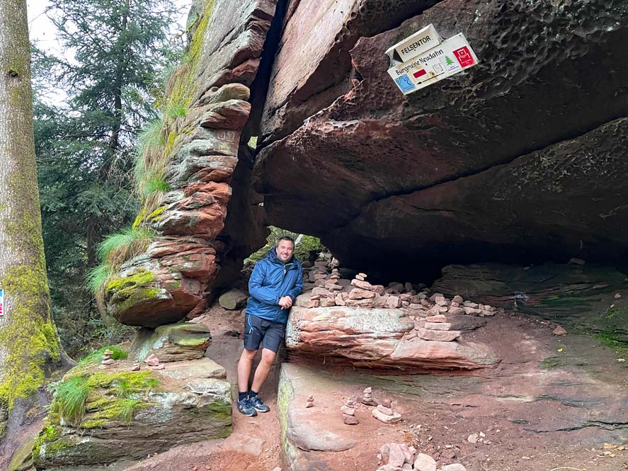 Wandern im Dahner Felsenland 🥾 7+ Tipps mann-steht-im-felsentor-in-dahn-rote-sandsteinfelsen
